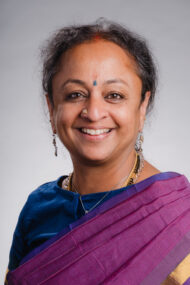 Portrait photograph of Supriya Nagarajan, facing the camera and smiling.